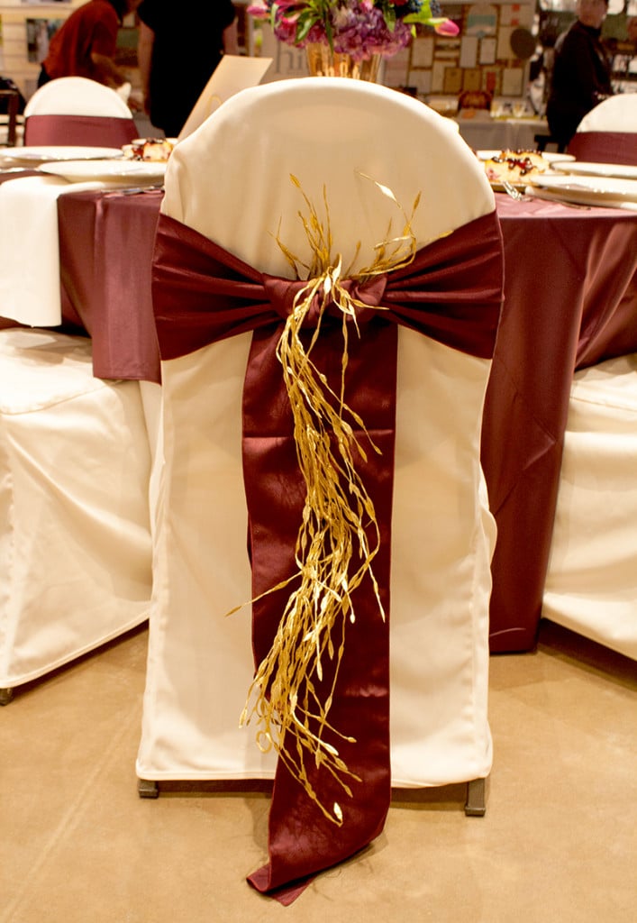 Navy + Plum + Gold Table (Chair covers and sashes by ABC Rentals, gold garland by Hitch Design Studio)