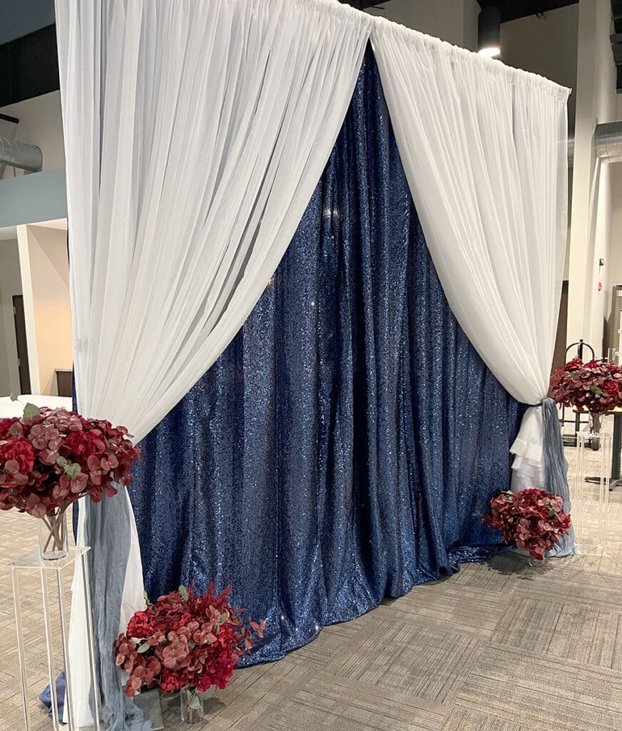 White draped arch with navy sequin backdrop