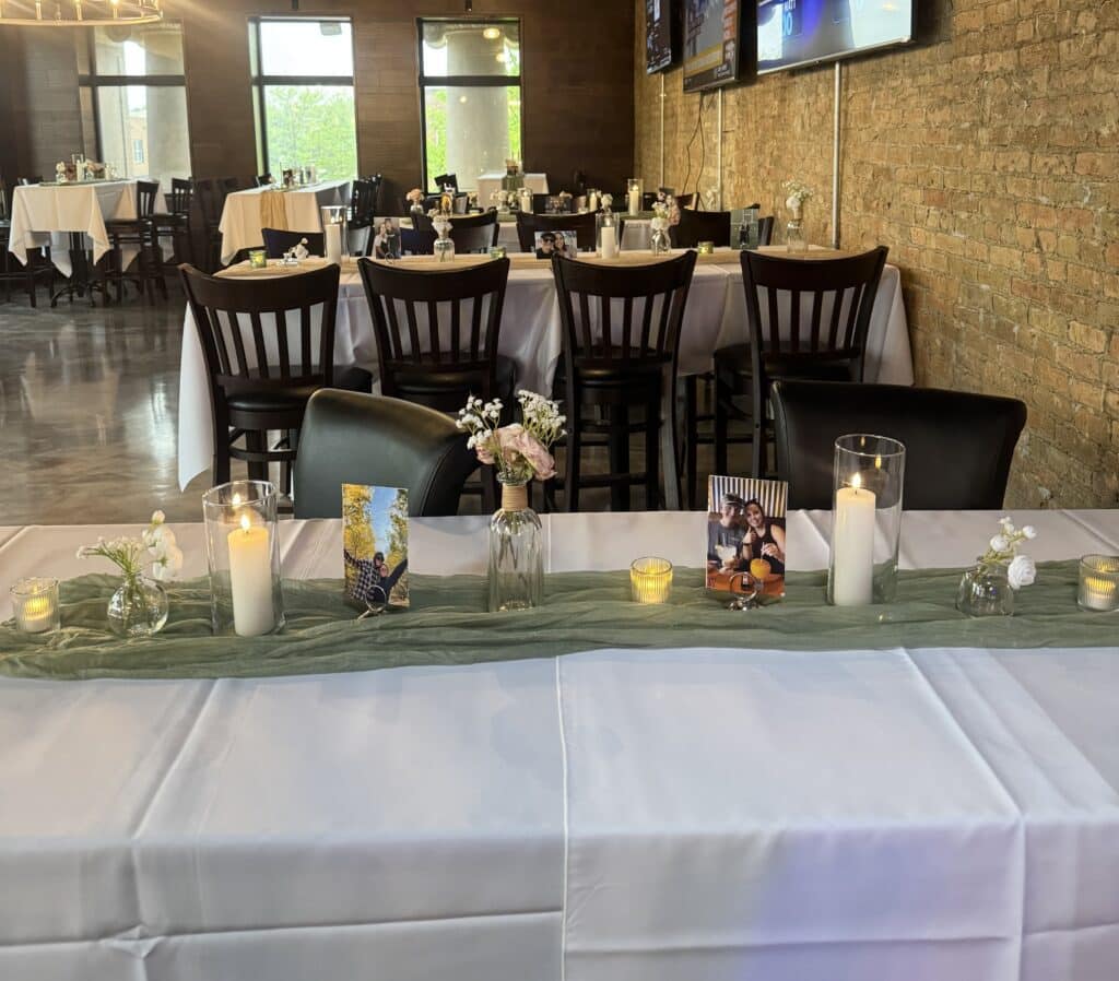 Candlelit reception tables with photos and floral centerpieces