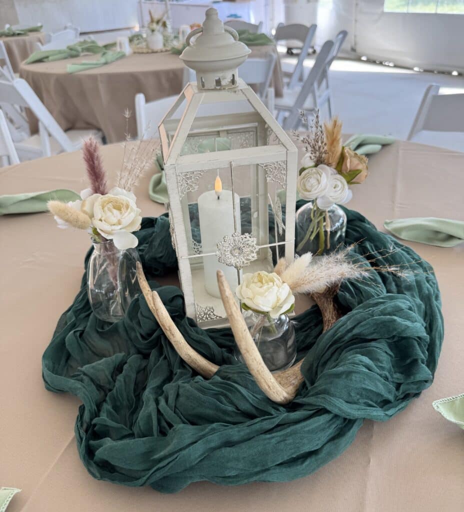 Rustic lantern centerpiece with flowers and antlers