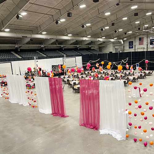 Large event hall decorated with pink balloons