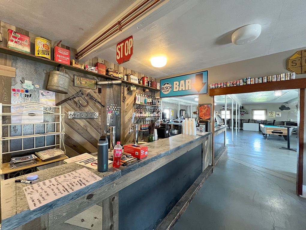 Rustic bar interior with vintage signs and pool tables