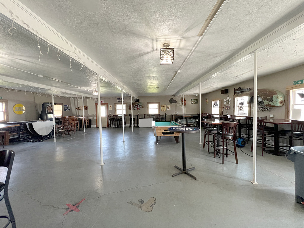 Spacious game room with pool table and dartboard