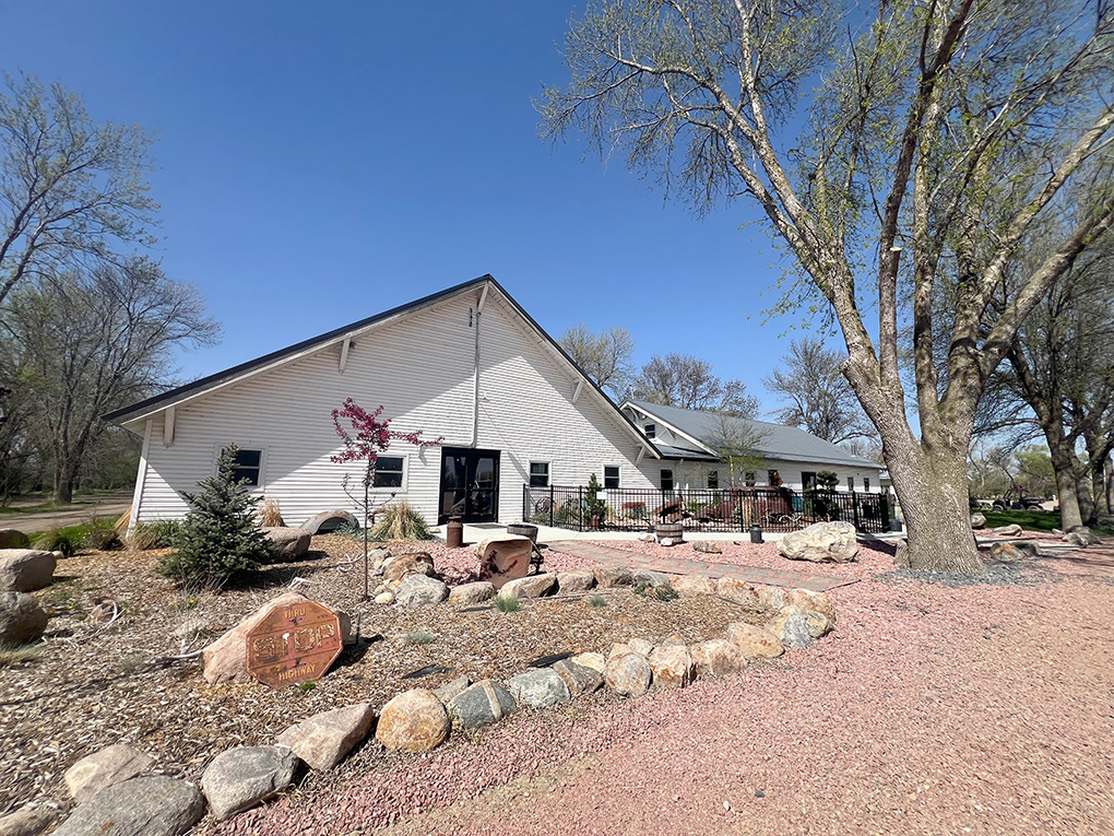Single-story building with landscaped gravel yard and trees
