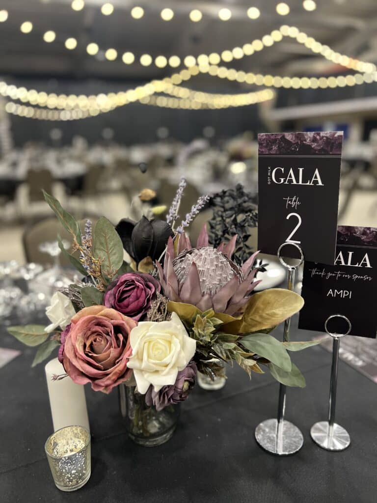 Floral centerpiece and Table 2 sign at gala
