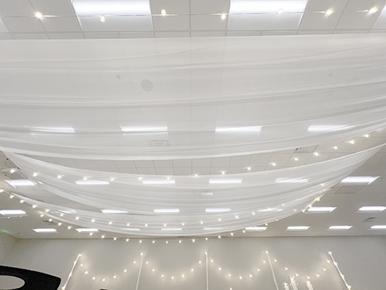 White draped ceiling with string lights indoors