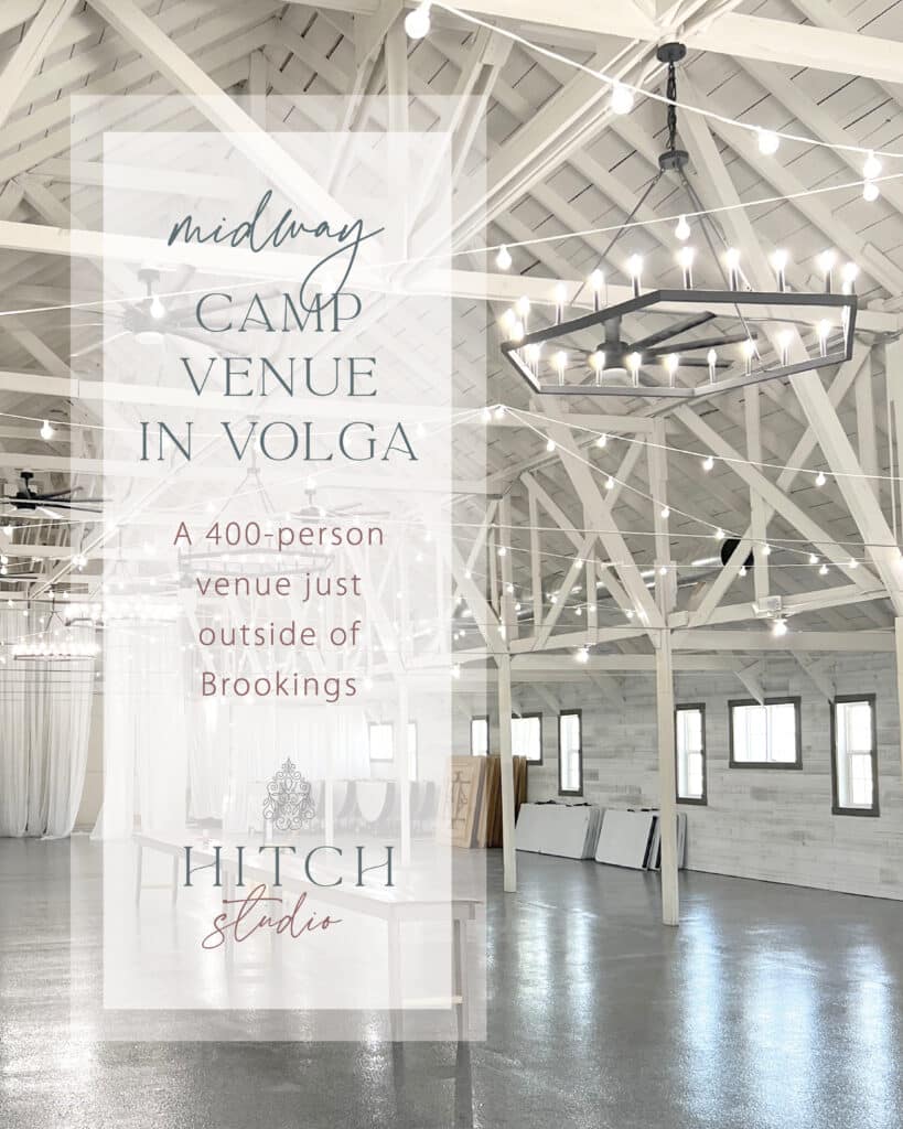 Rustic white barn wedding venue with chandeliers