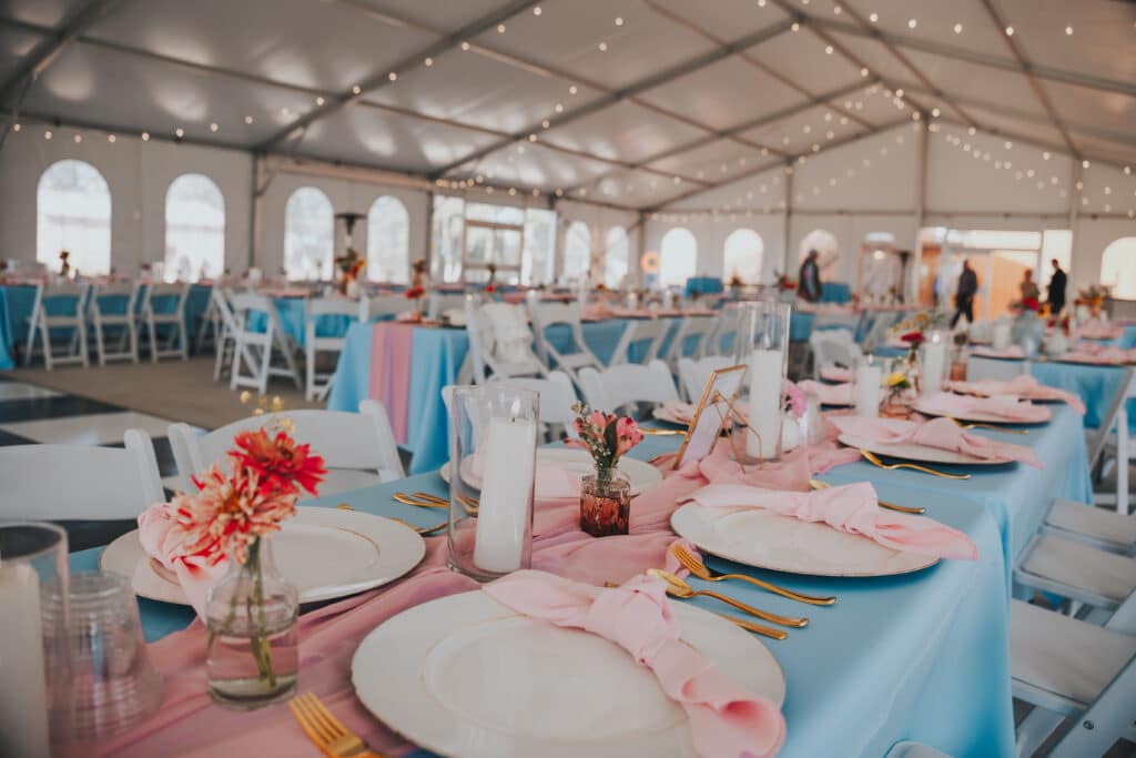 Elegant banquet tables with pink napkins and floral centerpieces