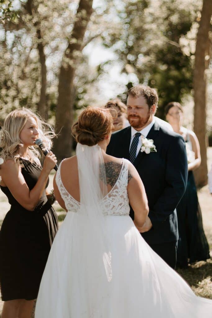 Bride and groom during a sunlit outdoor wedding ceremony