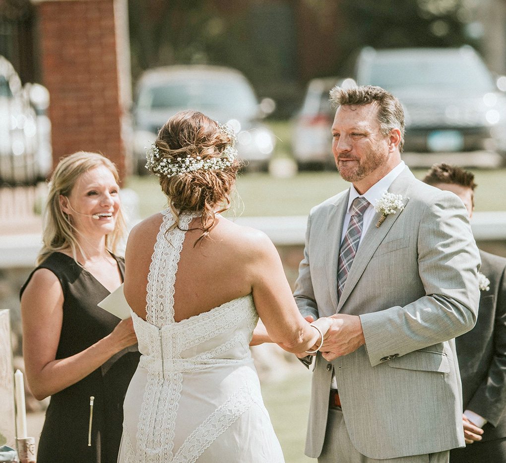 Bride and groom exchange vows during outdoor wedding ceremony