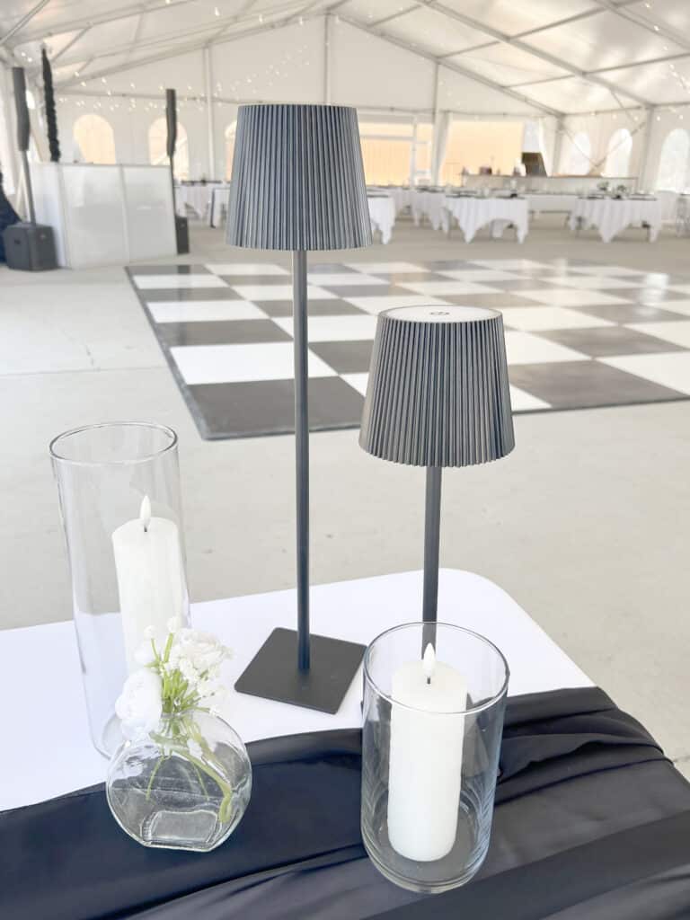 Elegant table lamps and candles in a bright event tent