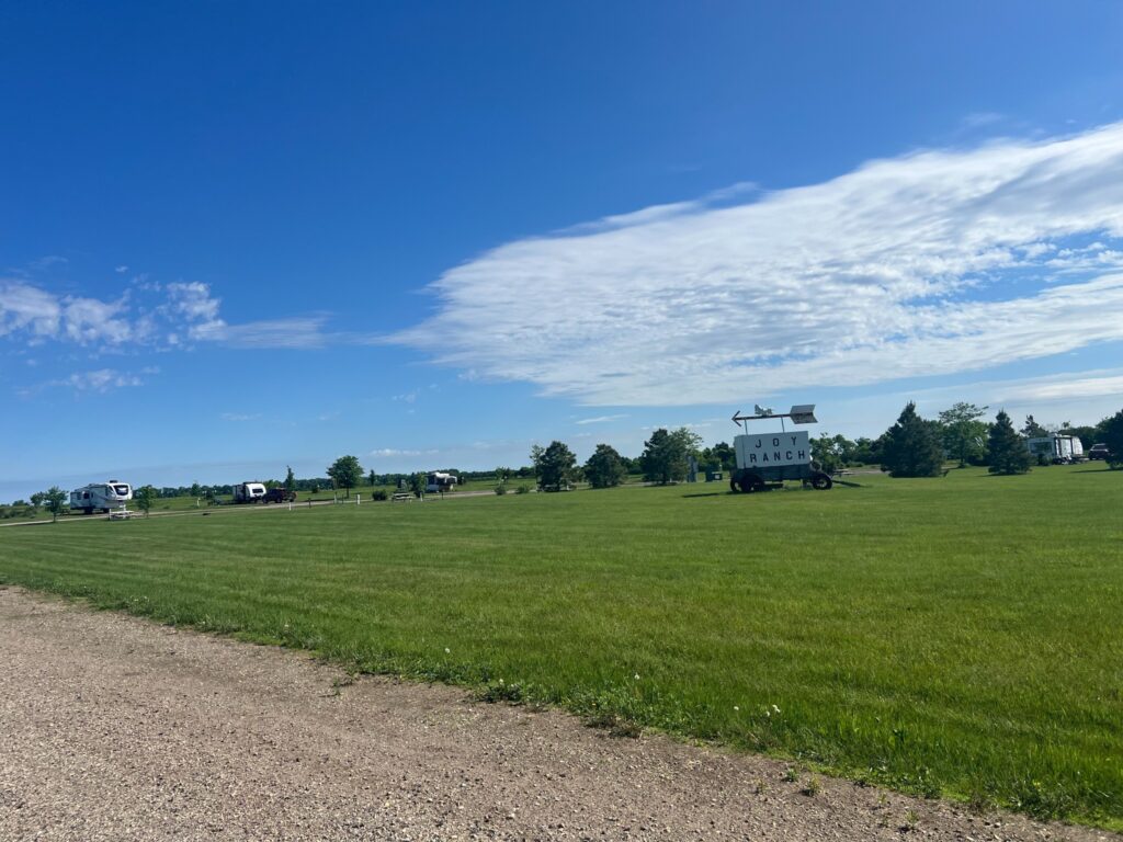 Joy Ranch campground beneath blue sky and sweeping clouds