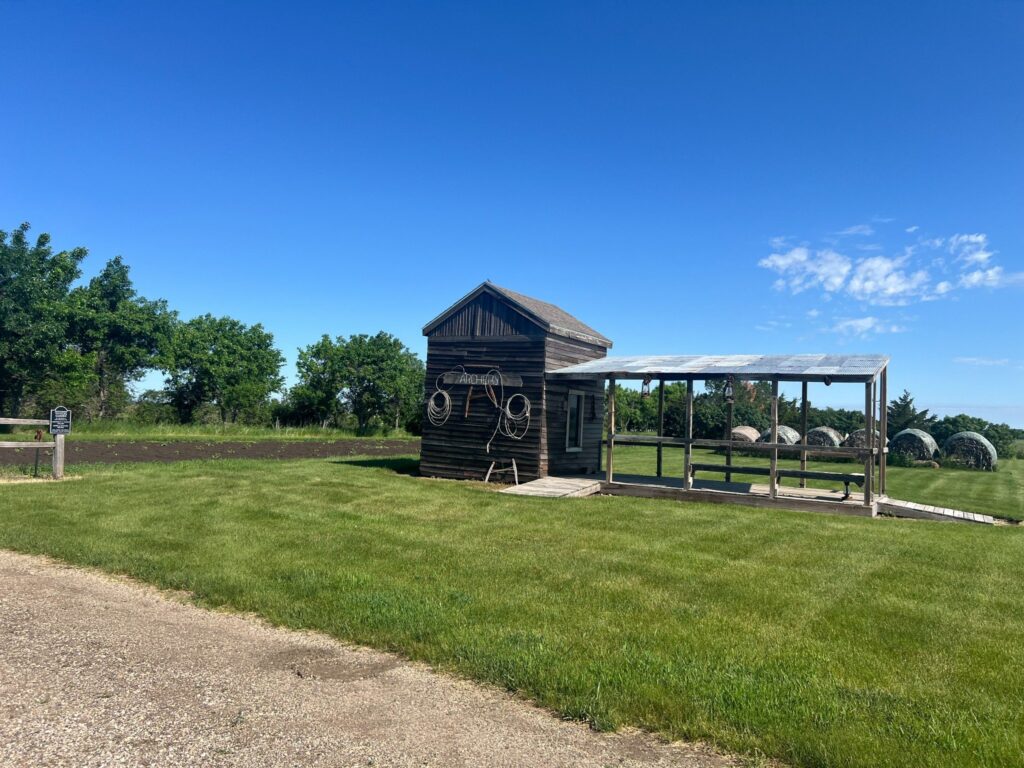 Rustic wooden archery shed beneath clear blue sky