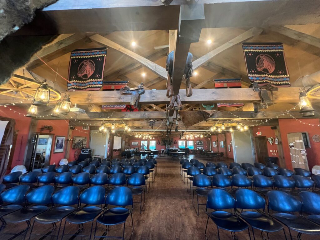 Western-themed event hall with rows of chairs