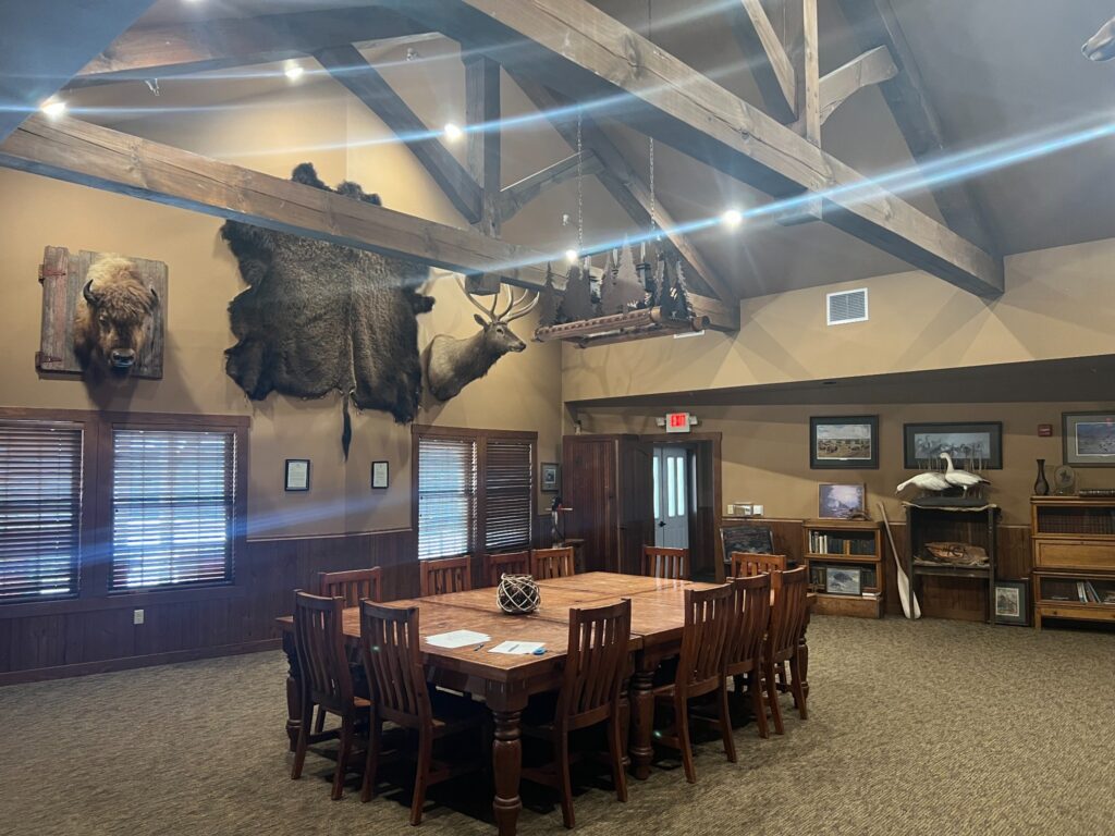 Rustic meeting room with wildlife mounts and wooden beams