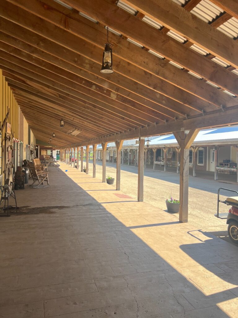 Sunlit covered wooden porch in a historic western-style town