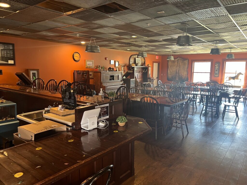 Rustic restaurant dining room with wooden tables and bar