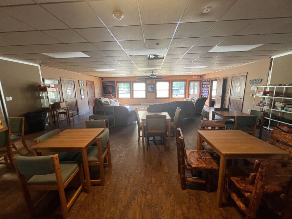 Spacious community lounge with tables, chairs, and sofas