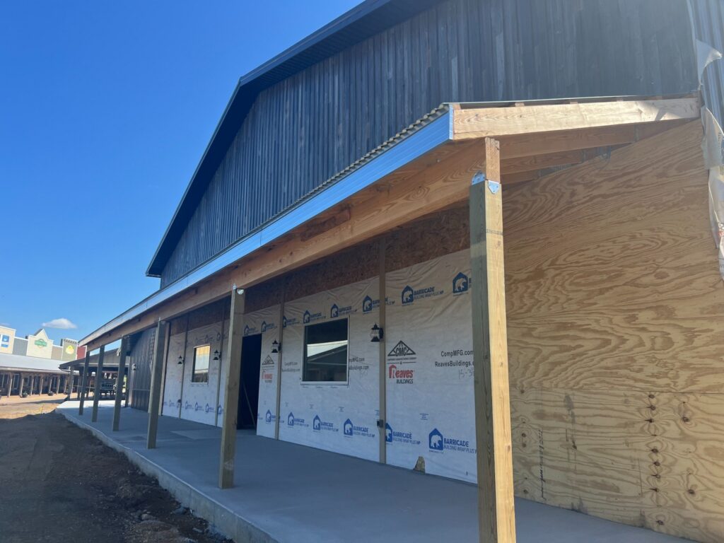 Commercial building under construction with covered wooden porch