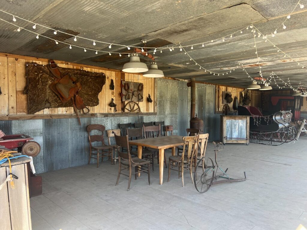 Rustic barn dining area with saddles and vintage sleigh
