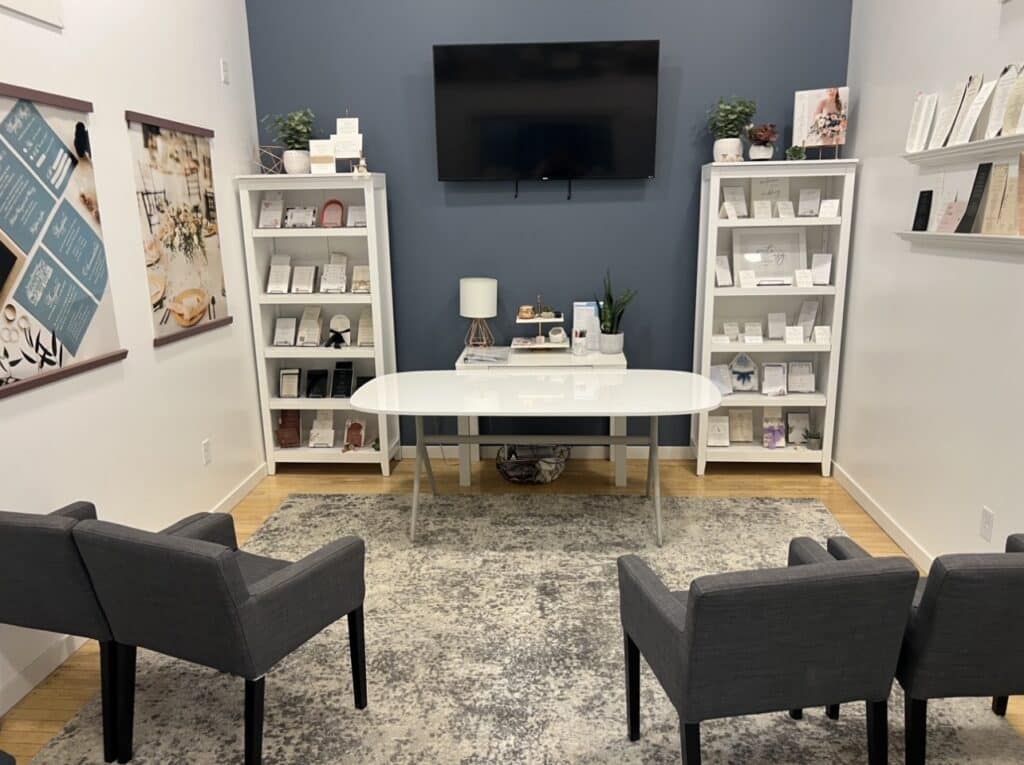 Elegant consultation room with desk, chairs, and invitation displays