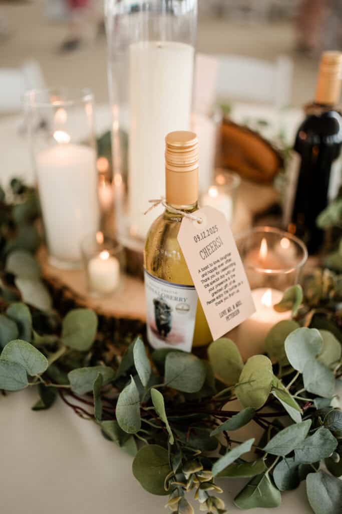 Small bottle with handwritten label beside green leaves