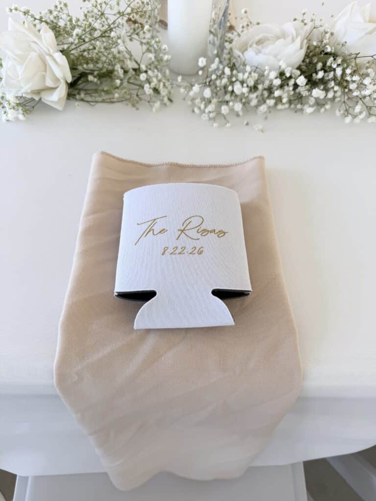 White floral bouquet beside a beige thank-you tote bag