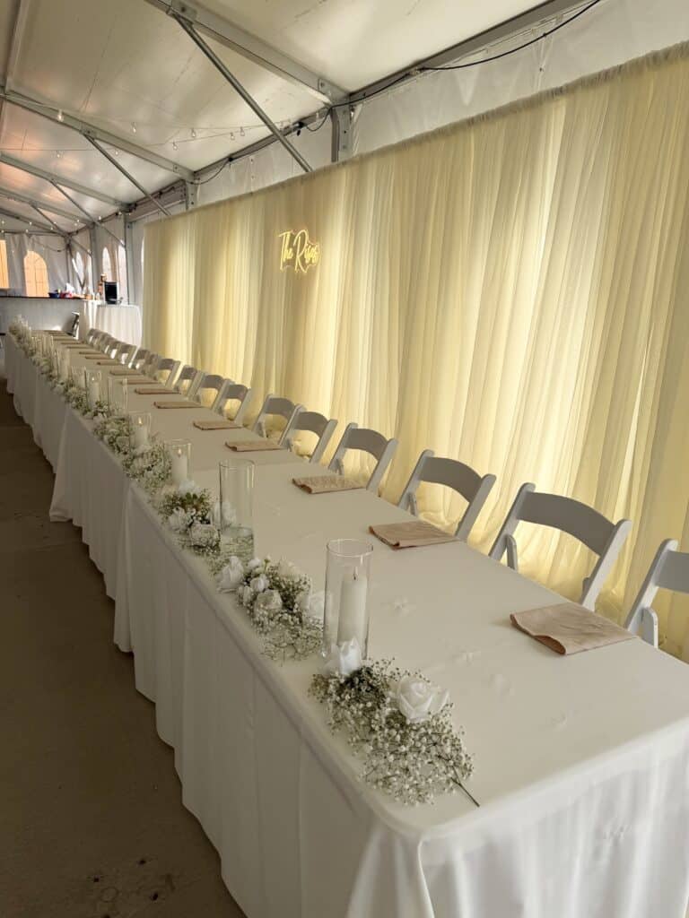 Elegant restaurant tables set with flowers and glass vases