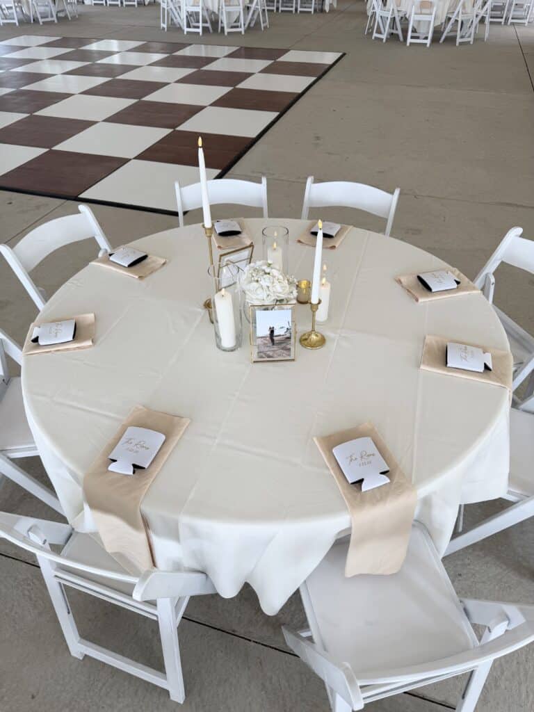 Elegant wedding reception tables with candles and white roses