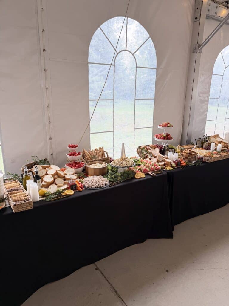 Elegant grazing table with breads, fruit, vegetables, and charcuterie