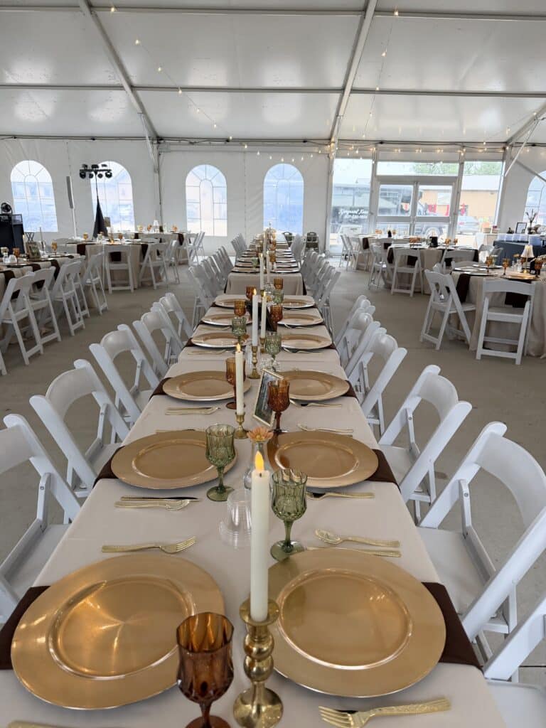 Elegant reception tables set beneath a white tent
