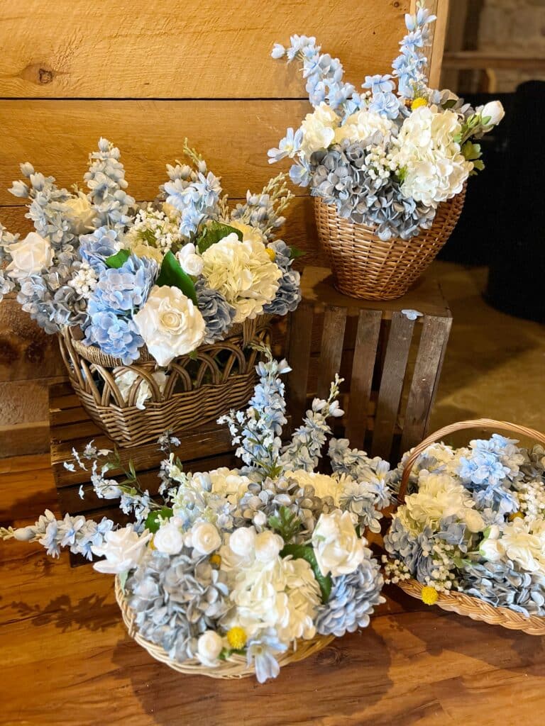 Blue and white artificial flowers in woven baskets
