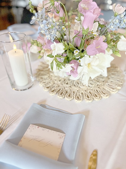 Pastel floral centerpiece on an elegantly set dining table