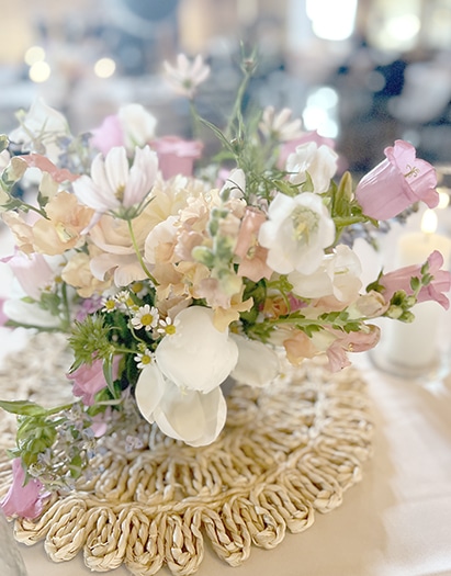Pastel flower bouquet atop a textured buttercream cake