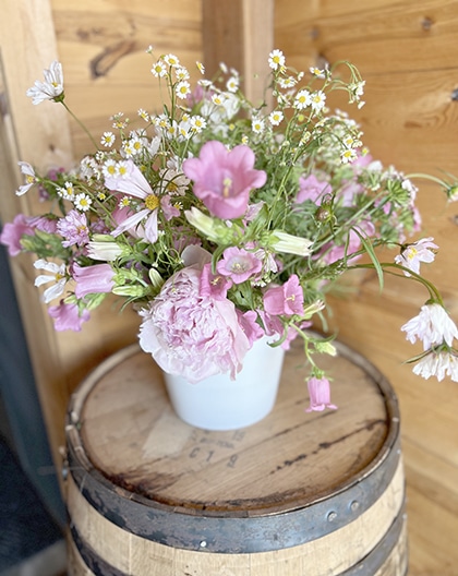 Pink and white wildflower bouquet in blue vase