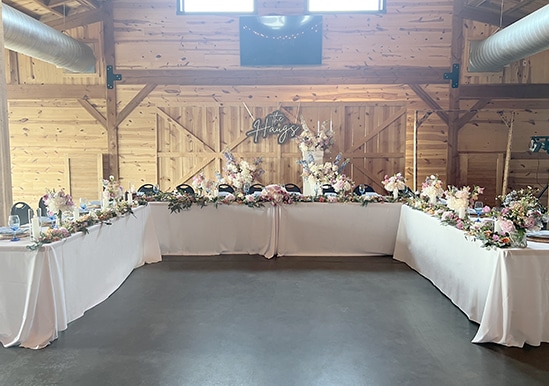 Rustic barn wedding reception with floral head table