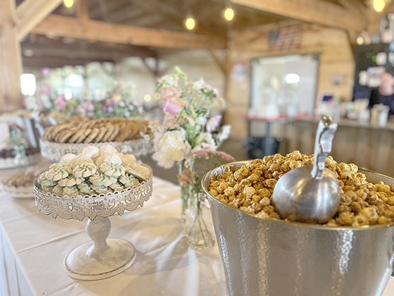 Caramel popcorn and desserts on a rustic event table