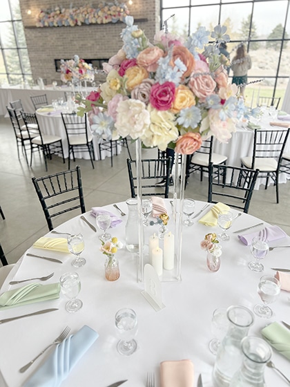 Pastel floral centerpiece on elegant wedding reception table