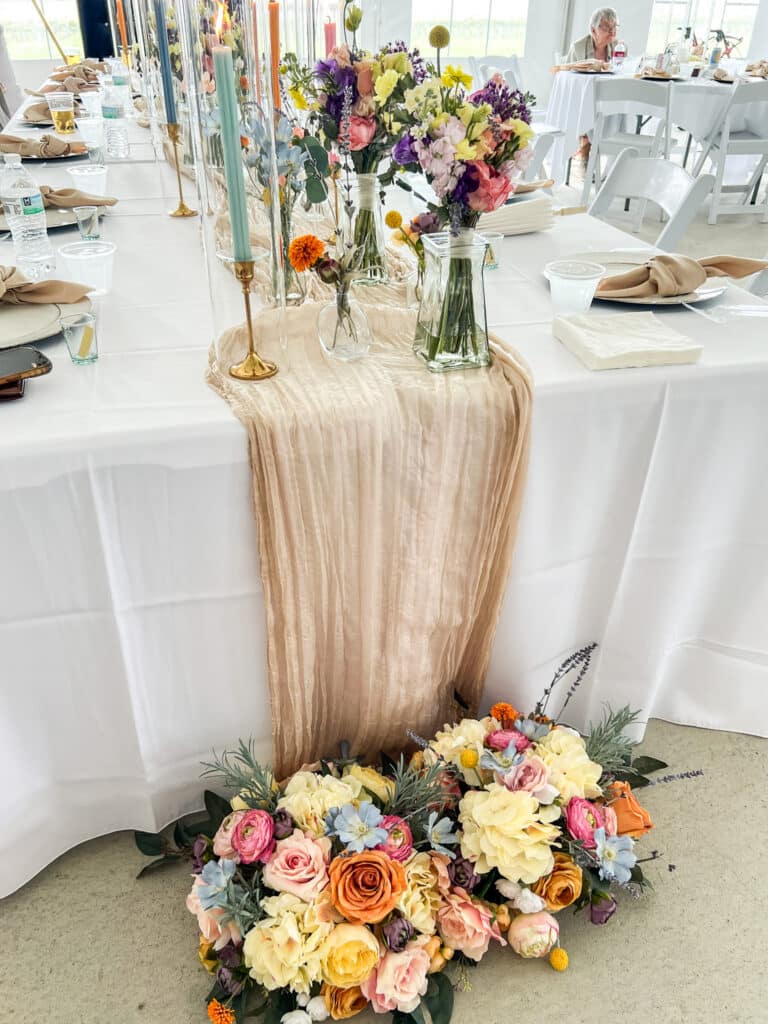 Colorful floral centerpiece on an elegantly set banquet table