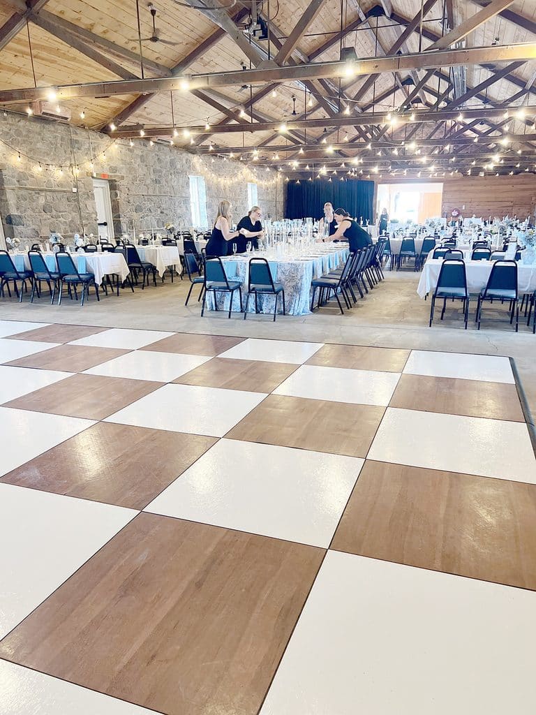 Rustic wedding reception hall with checkered dance floor
