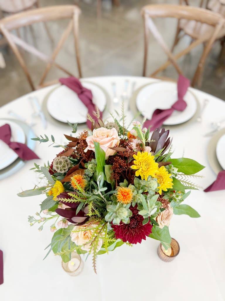 Colorful floral centerpiece on an elegantly set dining table