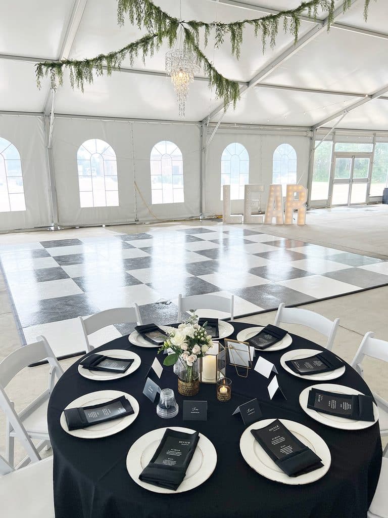 Elegant tent reception with black-and-white dance floor